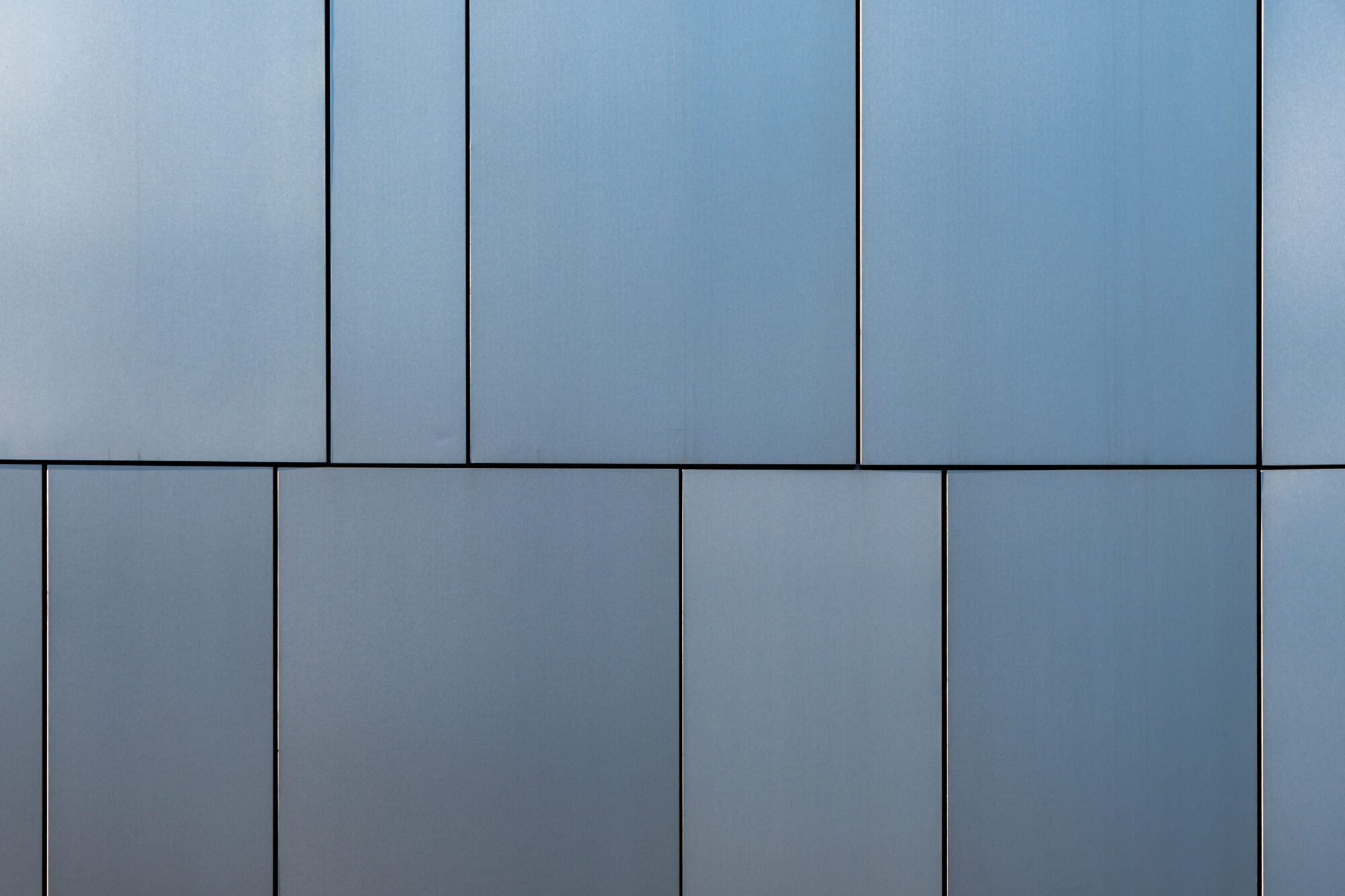 Stainless steel facade cladding shining in different grey and blue tones building elements