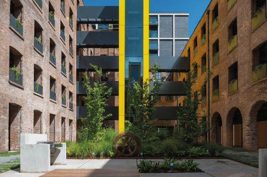 External view of the Phoenix apartment buildings featuring an external yellow lift shaft.
