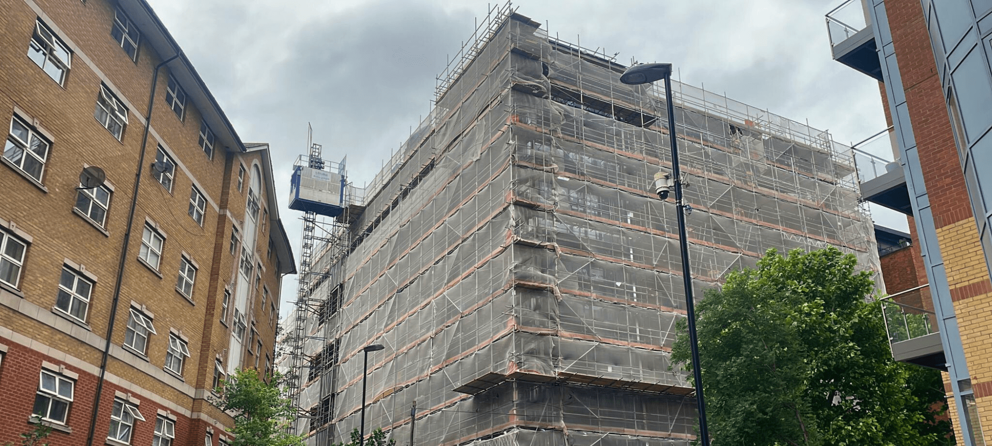 Seven-storey building in Croydon enclosed by scaffolding and suspended cradles