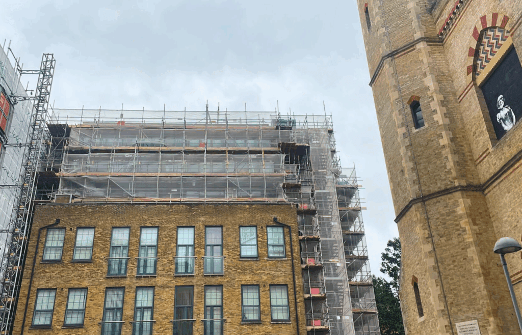 Seven-storey residential building in Croydon, enclosed by scaffolding