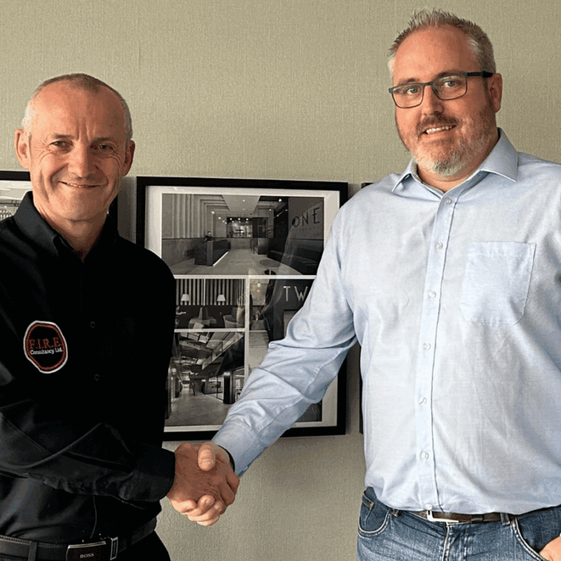 Blair Fotheringham from FIRE Consultancy and Dave Inglis from Urbanise Construction shake hands in the newly expanded office.