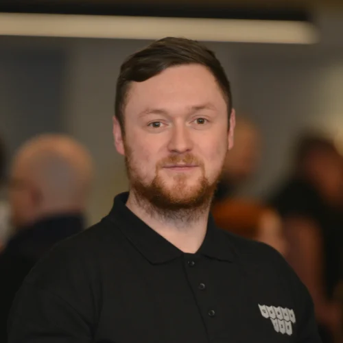 Headshot of Daniel smiling. He is wearing a black Urbanise branded shirt.