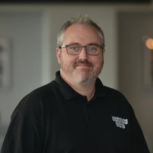 Headshot of Dave smiling. He is wearing a black Urbanise branded shirt.
