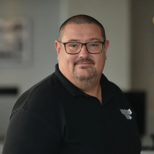 Headshot of Gary smiling. He is wearing a black Urbanise branded shirt.