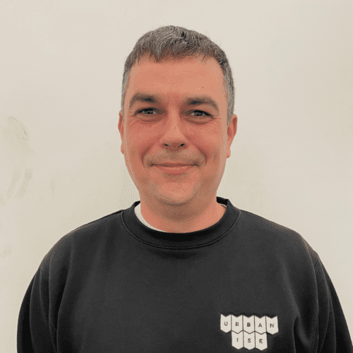 Headshot of Rob smiling. He is wearing a black sweatshirt with a white Urbanise logo on the left-hand side.